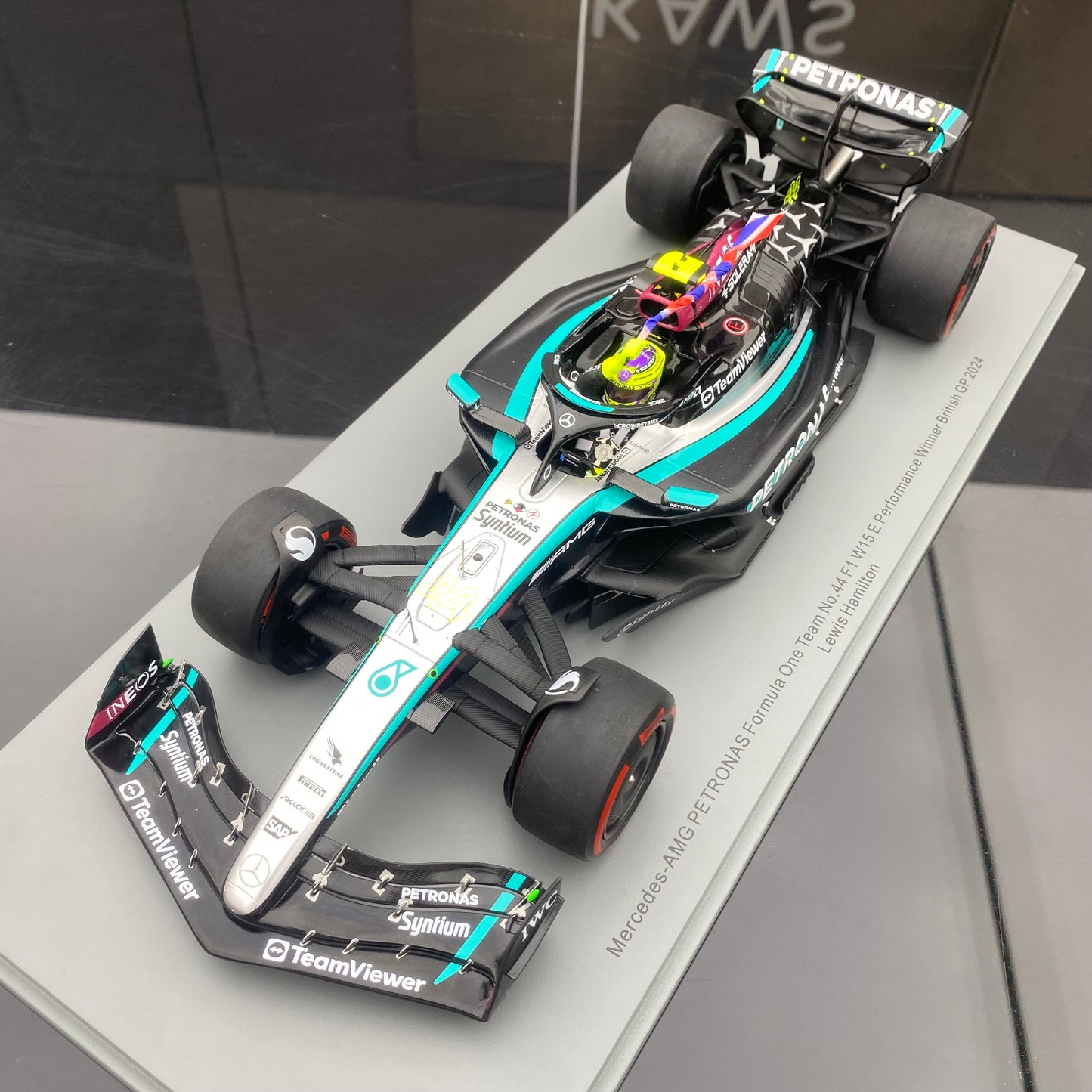 Spark 1/18 Mercedes-AMG W15 UK Grand Prix Victory No. 44 Hamilton Sitting and Holding the Flag Version