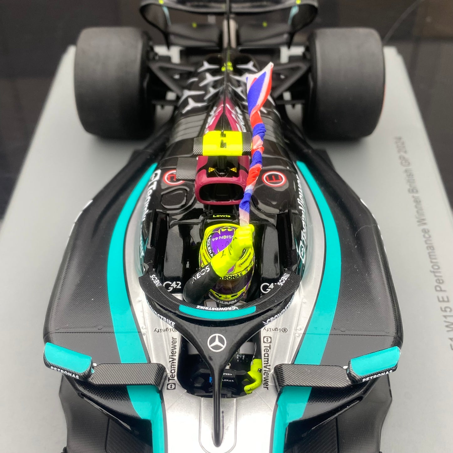 Spark 1/18 Mercedes-AMG W15 UK Grand Prix Victory No. 44 Hamilton Sitting and Holding the Flag Version