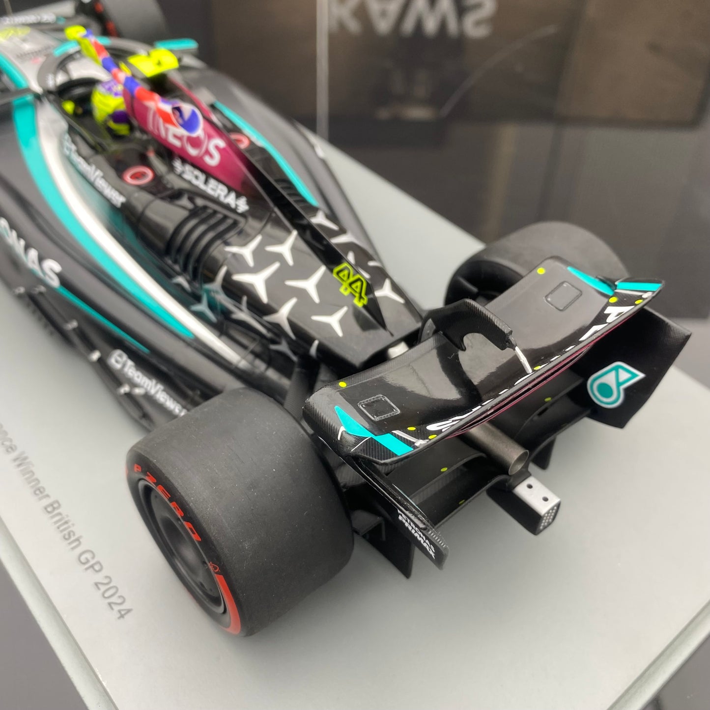 Spark 1/18 Mercedes-AMG W15 UK Grand Prix Victory No. 44 Hamilton Sitting and Holding the Flag Version
