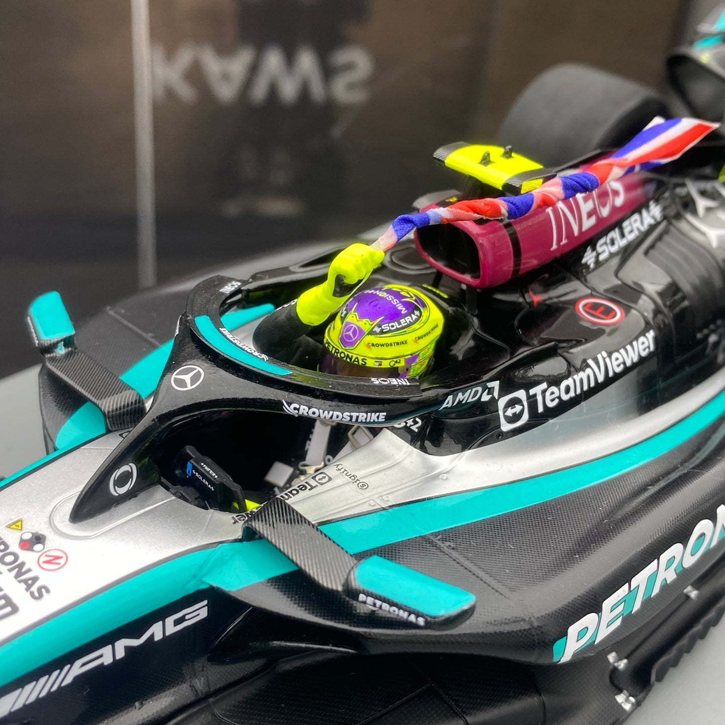 Spark 1/18 Mercedes-AMG W15 UK Grand Prix Victory No. 44 Hamilton Sitting and Holding the Flag Version